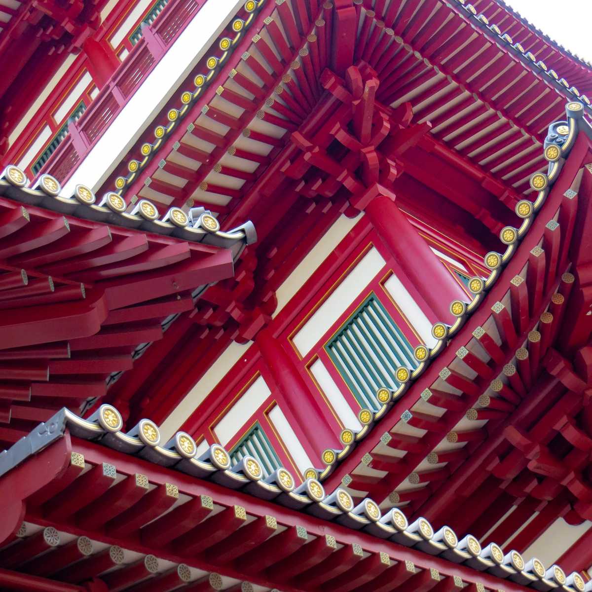 Looking up at the tiered red rooftops of the Buddha Tooth Relic Temple in Chinatown.