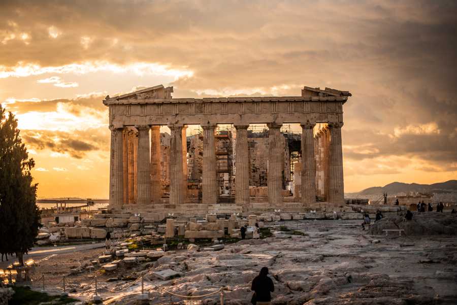 View of the Parthenon in front of a golden sky.